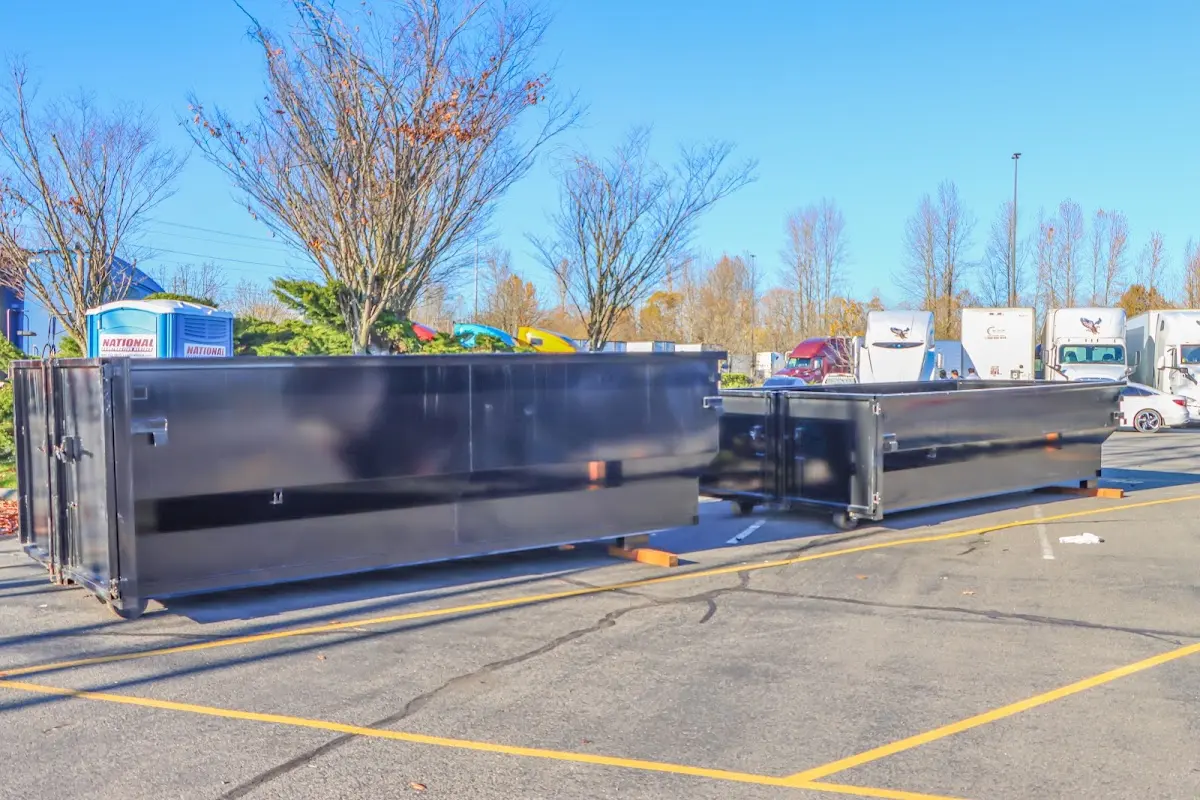 Professional dumpster rental service with roll-off container on residential driveway in Otsego